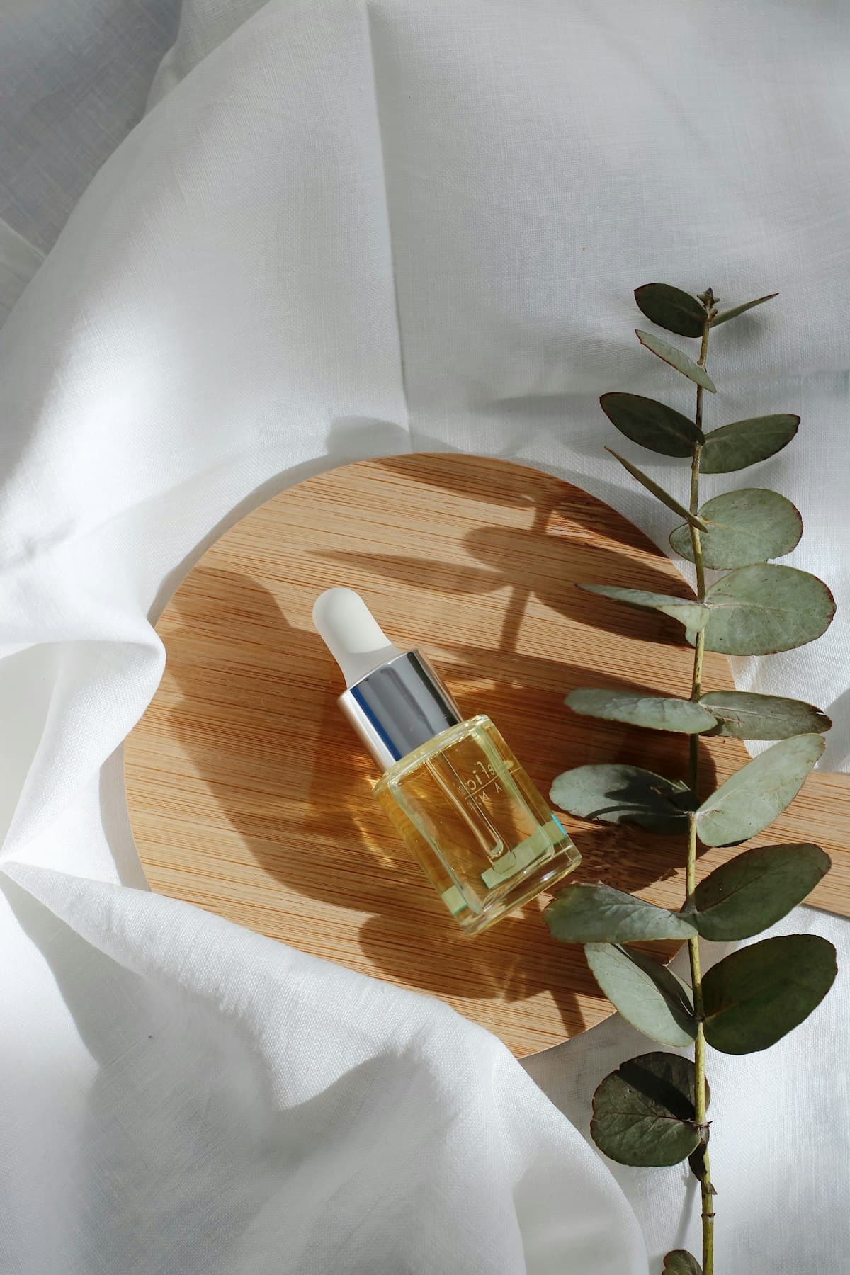 Skincare serum bottle with eucalyptus